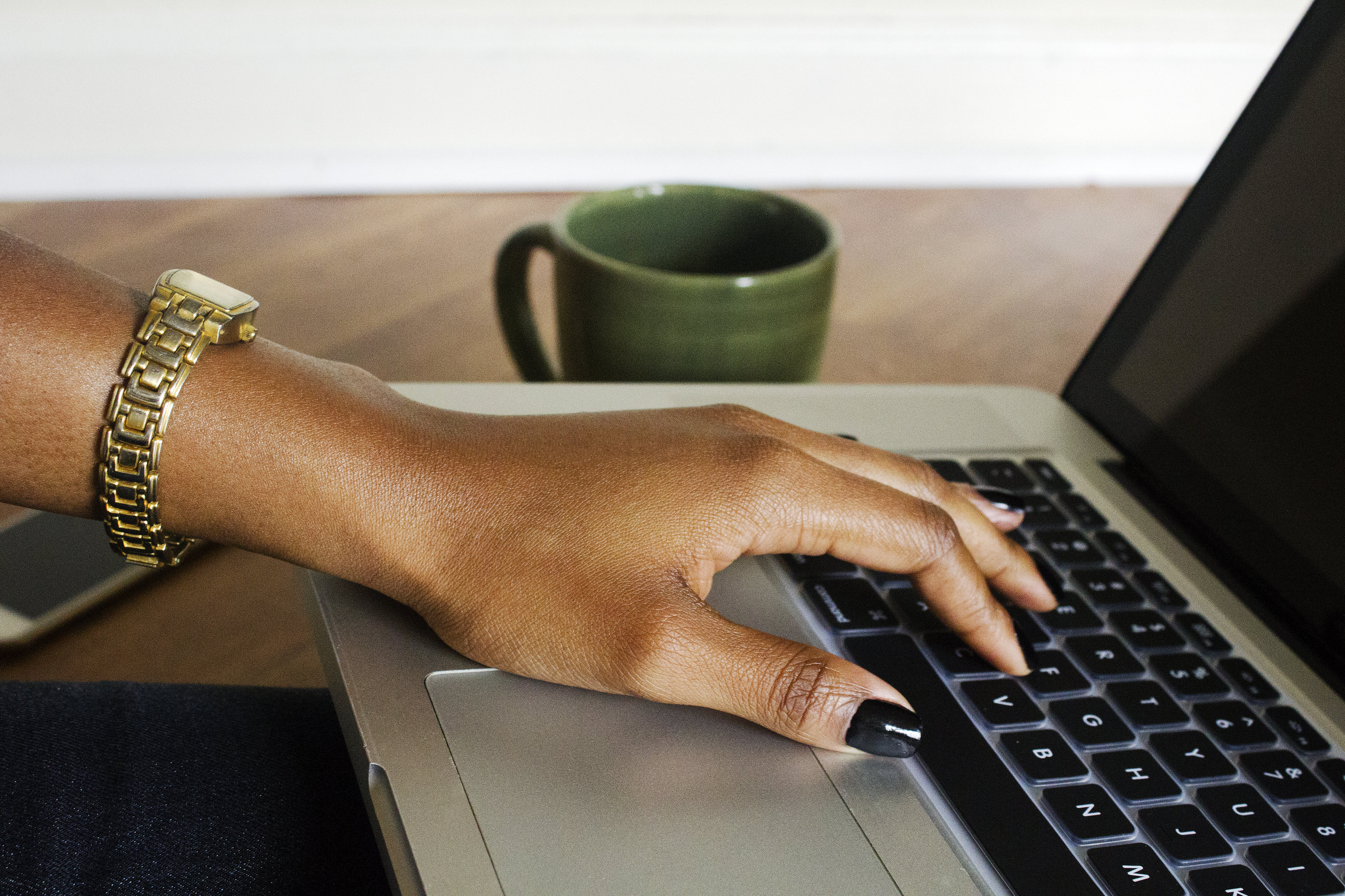 black-woman-hand-on-laptop-createherstock